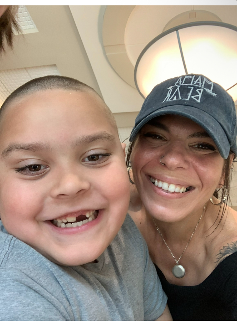 Ashlee Savia DeConinck smiling with her son Rocco